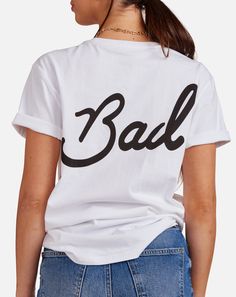 Clean, casual, & bad as hell. Rebellious Cotton T-shirt With Graphic Print, Rebellious Cotton Graphic Print Tops, Rebellious Cotton Tops With Graphic Print, Rebellious Cotton Tops For Streetwear, Rebellious Cotton Top With Graphic Print, Cool Relaxed Fit Slogan Tops, Cool Slogan Tops With Relaxed Fit, Edgy Cotton Slogan Tops, White Bad