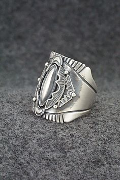 This finely crafted sterling silver ring was made by Navajo silversmith Derrick Gordon. The back is signed Derrick and stamped sterling.Size: 11Length: 1"Free shipping on all orders! We ship with USPS and always include tracking. All orders ship within a day of payment.Returns are accepted up to 30 days after you receive your order. Just send us a message. Our shop offers cash back or store credit. The item must be returned in new condition. Southwestern Silver Rings Collectible, Silver Southwestern Style Rings, Southwestern Silver Collectible Rings, Collectible Southwestern Silver Ring, Southwestern Style Untreated Silver Rings, Western Silver Turquoise Ring Stamped 925, Silver Turquoise Concho Ring In Sterling Silver, Artisan Sterling Silver Engraved Ring, Bohemian Silver Rings With Polished Finish