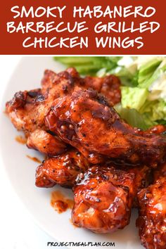 barbecue grilled chicken wings on a white plate with lettuce