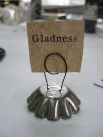 a place card holder on top of a table at a wedding or other event with the name gladness