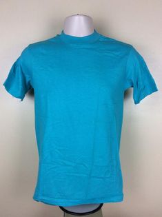 Vintage 80s Hanes plain turquoise t-shirt.  Soft 100% cotton, made in USA.Excellent condition, like never worn.  No holes, no stains, no issues.Size S, but fits slightly smaller than today’s S.  Please note measurements to avoid returns: laid flat measures 17” across chest (armpit to armpit), 26.5” length (top of center of collar on back to bottom of shirt). Turquoise Crew Neck T-shirt For Summer, Casual Turquoise Crew Neck T-shirt, Turquoise Fitted Tank Top, Blue Washed Relaxed Fit T-shirt, Plain White T's, Soft-washed Blue Short Sleeve T-shirt, Cheap Turquoise Short Sleeve T-shirt, Kenny Loggins, Turquoise Cotton Crew Neck T-shirt