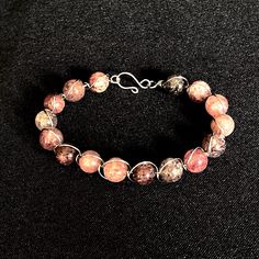 Stunning strawberry quartz bracelet featuring a beautiful blend of pink gemstone beads. Handmade with care, this beaded bracelet is expertly crafted and wrapped with durable 304 stainless steel wire, ensuring both elegance and longevity. Perfect for any occasion, this unique piece embodies the essence of a goddess, making it a must-have addition to your jewelry collection. All of my jewelry is designed and handmade in my home jewelry studio.  I ship all jewelry in boxes, not bubble mailers, and Rhodonite Natural Stone Bracelets As A Gift, Wire Wrapped Bracelets With Round Beads As Gift, Beaded Rose Quartz Round Bead Jewelry, Wire Wrapped Bracelets As A Gift, Pink Spiritual Bracelets Hand Wrapped, Pink Hand Wrapped Round Beads Jewelry, Hand Wrapped Pink Round Beads Jewelry, Pink Hand Wrapped Round Bead Jewelry, Hand Wrapped Pink Round Bead Jewelry