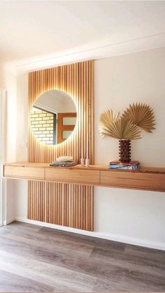 a mirror sitting on top of a wooden shelf