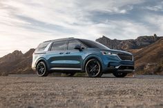 a blue suv parked on the side of a road