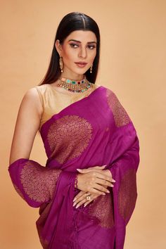 Look your ethnic best at weddings and special occasions in this purple tussar Banarasi saree. It is adorned with antique zari buta. The saree comes with a green blouse piece. Disclaimer: The shown stitched blouse on the model is for display purpose only. The saree comes with a matching blouse piece and finished with fall and piko.