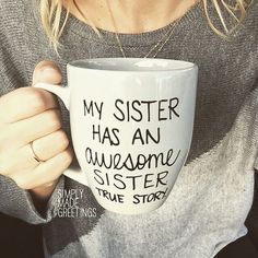 a woman holding a coffee mug with writing on it that says, my sister has an awesome sister true story