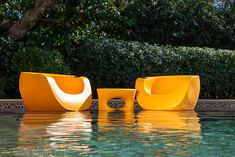 two yellow chairs sitting next to each other in the water