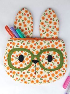 an animal shaped pencil case with glasses on it