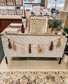 a table that has some items on top of it in front of a window with balloons