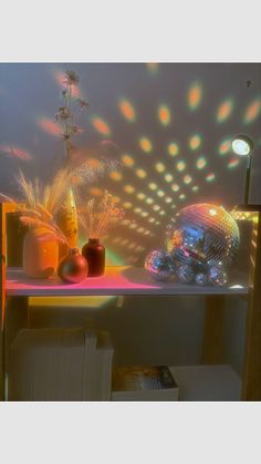 a table topped with vases filled with flowers and disco balls