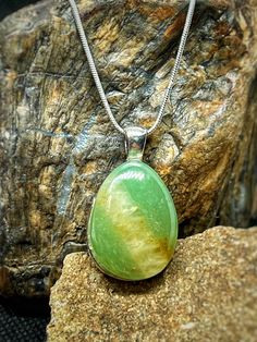 This beautiful, self collected green Aventurine from Western Wyoming has been cut and polished to a teardrop shape in our lapidary shop. It displays a beautiful shimmering 'apple' green with a vein of white quartz across the stone.  The stone was set on an engraved silver plated brass setting. Then a 1mm silver plated brass snake chain was added.  Snag this beautiful piece while it's available! Green Pear-shaped Drop Necklace Gift, Green Pear-shaped Drop Necklace For Gift, Green Teardrop Spiritual Necklace, Green Teardrop Gemstone Drop Necklace, Western Wyoming, Lake Superior Agates, Silver Snake Chain, Pretty Green, Silver Engraving