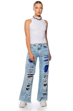 The Your New Favorite Distressed Patchwork Flared Jeans is a chic, distressed acid-washed denim moment made from a non-stretch cotton base fabrication. It features a relaxed fit mid-rise waist, distressed accents, and bandana patchwork. Complete with frayed distressed hems, classic five-pocket design, and a buttoned zip-up front closure. Style with a lace bodysuit and platform sandals for a finished, weekend look. - 100% Cotton(all measurements approximate from size 26)- 11” Rise- 30” Inseam- Model is 5'8"- ImportedProduct ID: 366588 Relaxed Fit Jeans, Washed Denim, Flared Jeans, Lace Bodysuit, Pocket Design, Denim Wash, Zip Up, Platform Sandals, Stretch Cotton