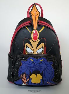 This is a Loungefly Disney Aladdin Jafar Villains Scene mini backpack.  Beautiful and durable cross-hatch black faux leather with the Jafar and the Cave of Wonders scene and black hardware.  Includes Iago the scarlet macow enamel zipper pull.  The bag is lined in black with Jafar and cobra print. Dimensions: 10.5"H x 9”W x 4.5”D This item is new...not pre-owned.  Impeccable condition.  The backpack was only removed from its original packaging for photos.  The item has been carefully stored in a Black Backpack For Theme Parks, Black Disney-style Bag For Theme Park, Black Disney Bag For Theme Park, Black Disney Style Bag For Theme Park, Black Backpack For Theme Park, Black Disney Backpack For Travel, Themed Black Backpack For Theme Parks, Black Disney Backpack For Disney Fan Events, Black Backpack With Zipper For Disney Fan Events