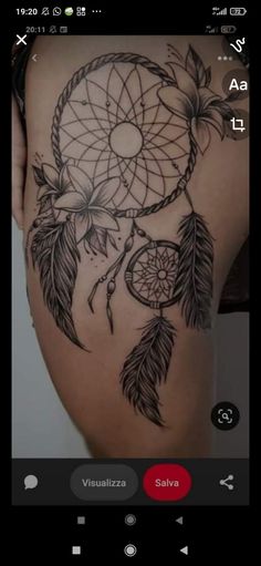 the back of a woman's stomach with a black and white dream catcher tattoo on it