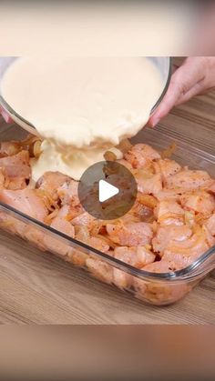 someone is adding sauce to shrimp in a casserole dish