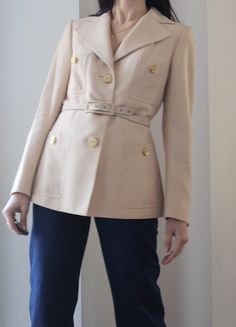 Beautiful vintage tailoring 70s cream pure wool blazer. Four front pockets, amazing buttons. The belt is not in perfect condition, it can be easily replaced with a leather one or with a printed silk scarf. Fully lined. Excellent vintage conditions, two very tiny signs of age as you can seen in the last photo. Best fit size 6 and 8 uk. (XS/S) Shoulder to shoulder 38 cm Bust 45 cm Waist 41 cm Hips 46 cm Length 63 cm Model's size 6 uk, h 163 cm. Classic Winter Blazer With Belt Loops, Beige Belted Outerwear For Office, Cream Wool Blazer For Office, Cream Wool Blazer For Work, Classic Beige Outerwear With Belt Loops, Beige Belted Blazer For Office, Retro Single Breasted Beige Blazer, Retro Single-breasted Beige Blazer, Vintage Beige Single-breasted Blazer