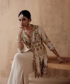 Editor's Note Presenting an elegant ivory kurta adorned with intricate floral thread embroidery, beautifully highlighted with various embellishments. This exquisite ensemble is paired with a stylish sharara, creating a sophisticated and graceful look perfect for special occasions or festive events. The combination of the detailed embroidery and the classic silhouette of the sharara adds a touch of timeless charm, making this outfit a tasteful choice for those who appreciate classic beauty with a Floral Thread Embroidery, Detailed Embroidery, Charm Making, Thread Embroidery, Thread Work, Classic Beauty, Classic Silhouette, Diwali, Floral Embroidery