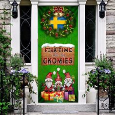 a green door decorated with christmas decorations and gifts in front of a brick building that says,'fika time with my gnomes '