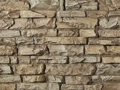 a stone wall that is made out of various types of rocks