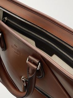 Investing in a smart briefcase, such as this one from Berluti, for important meetings and conferences will help to ensure you make the right impression. It's been made in Italy from the label's signature Venezia leather that will age well over time and unzips to reveal a spacious interior with organisational pockets. Carry it by the top handles or attach the shoulder strap to wear it over your shoulder. Italian Leather Briefcase For Formal Use, Saffiano Leather Briefcase With Top Handle For Business, Saffiano Leather Briefcase With Top Handle For Office, High-end Brown Rectangular Briefcase, Top Handle Briefcase With Palladium Hardware For Business, Luxury Cognac Briefcase For Business Trips, Saffiano Leather Briefcase With Palladium Hardware, Saffiano Leather Briefcase With Palladium Hardware For Business, Designer Leather Briefcase For Business