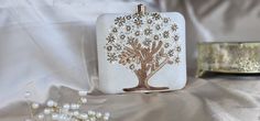 a white purse with a tree on it