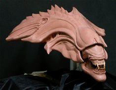 an alien mask with teeth and fangs on it's head