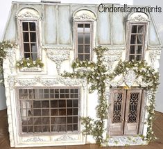 a doll house with ivy growing on the side and windows in it's sides