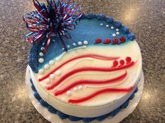 a cake decorated with red, white and blue icing on a marble counter top