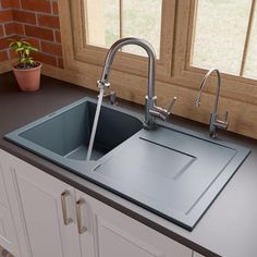 a black kitchen sink sitting next to a window