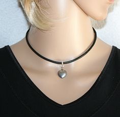 Leather choker with a silver-colored heart pendant made of stainless steel. This cute heart pendant is very trendy, looks romantic but also playful, is very suitable for special or informal occasions, is also perfect for the ideal gift.  Leather cord 0.118 Inch black color stainless steel heart pendant 0.51 x 0.59 x 0.11 Inch stainless steel lobster clasp with extension chain Black Leather Choker, Choker Black, Pendant Choker, Gift For Her Birthday, Leather Chokers, Black Choker, Silver Heart Necklace, Jewelry Silver, Steel Jewelry