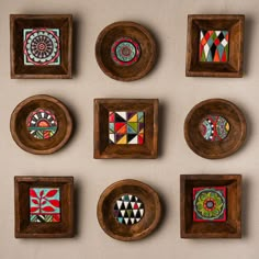 six wooden plates with designs on them are arranged in a gridlocked pattern against a white wall