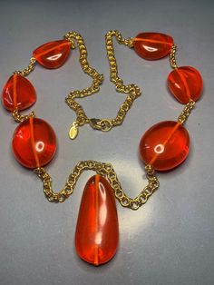 WONDERFUL DESIGNER KENNETH jay lane Long Gold Orange Large Resin Drops Necklace Avantgarde Runway Glamour Statement Couture Signed Vintage Featuring a gorgeous long necklace by Kenneth jay lane, Large resin orange drops in between a gold chain.Very striking and yet catching. Signed on Tag, comes in pouch and original box. Kenneth Jay Lane was one of my favourite customs jewellery designers, Many famous people were his clients, from Jacky Onassis to Madonna, Princess Diana to other Royals!! This Drops Necklace, Lana Lang, Jackie Onassis, Brass Necklace, Gold Orange, Custom Jewelry Design, Kenneth Jay Lane, Drop Necklace, Orange Gold