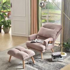 a pink chair and ottoman in a living room