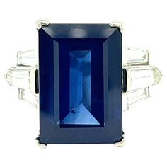 Sapphire Diamond Cocktail Ring Rectangular step-cut sapphire of 12.25 carats (16.01 x 10.94 x 6.41 mm), with four near-colorless tapered baguette diamonds and two modified kite step-cuts; mounted on platinum Size: 6.25 US Total weight: 11.7 grams Comes with GIA certificate no. 2231015890, dated July 25, 2023 Formal Octagon Sapphire Ring In Platinum, Octagon Sapphire Diamond Ring, Rectangular Brilliant Cut Sapphire Ring For Formal Occasions, Formal Octagon Sapphire Diamond Ring, Octagon Brilliant Cut Sapphire Ring For Formal Events, Classic Sapphire Ring With Rectangular Stone, Formal Octagon Brilliant Cut Sapphire Ring, Formal Octagon Sapphire Ring With Brilliant Cut, Rectangular Brilliant Cut Sapphire Ring