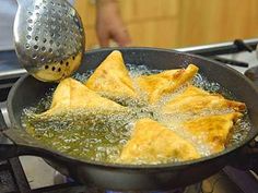 food being cooked in a frying pan on the stove