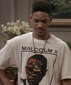 the young man is wearing a t - shirt with an image of malcolm x on it