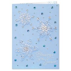 a blue christmas card with snowflakes and crystals on the front, says because of the season