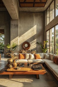 a living room filled with furniture and lots of windows