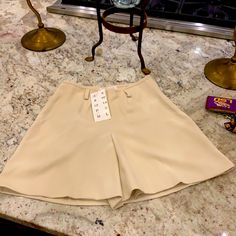 Brand New With Tags. Beautiful Bone Color . See Measurements Size 4 Beige Mini Skirt For Day Out, Chic Mini Shorts With Pockets, Trendy Beige Wide-leg Shorts, Trendy Fitted Wide-leg Shorts, Beige Mini Bottoms For Day Out, Beige Mini Length Bottoms For Day Out, Trendy Beige Mini Length Bottoms, Short Skirt For Summer Workwear, Summer Workwear Short Skirt