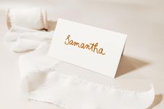 a piece of paper with the word sammatha written on it next to a roll of toilet paper