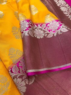 Beautiful Mango Yellow Banarasi Handloom Saree with Pink Border with Floral Patterns with Wide Border Cooper Zari used in Border and Pallu. Item : SareeColor : Mango Yellow and Pink Base Fabric : Banarasi Silk (Non-Pure) Blouse piece : Comes with Blouse pieceBlouse material : Banarasi Silk (Non-Pure) Fall & Edging: Comes with Fall and edging (Pico) and tassels attached Disclaimer -:- Color variation is possible due to various reasons like phone or desktop setting, resolution etc. Please don't ho Diwali Lehenga In Tissue Silk With Traditional Patterns, Festive Yellow Brocade Saree, Yellow Banarasi Silk Sets With Zari Weaving, Yellow Art Silk Handloom Sets, Yellow Banarasi Silk Blouse Piece For Season Transition, Transitional Yellow Banarasi Silk Blouse Piece, Yellow Handloom Choli For Navratri, Yellow Sets With Zari Weaving For Festivals, Yellow Blouse Piece With Zari Weaving For Traditional Ceremonies