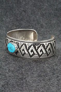 This beautiful turquoise and sterling silver bracelet was made by Navajo silversmith Richard Singer. The back is signed R Singer and stamped .925.Size: 6 7/8" (will fit up to a 8" wrist)Gap: 1 1/8"Width: 1"Free shipping on all orders! We ship with USPS and always include tracking. All orders ship within a day of payment.Returns are accepted up to 30 days after you receive your order. Just send us a message. Our shop offers cash back or store credit. The item must be returned in new condition. Blue Southwestern Style Bracelets Stamped 925, Southwestern Style Turquoise Bracelet Stamped 925, Southwestern Style Stamped Turquoise Bracelets, Southwestern Style Turquoise Stamped Bracelets, Traditional Turquoise Sterling Silver Cuff Bracelet, Traditional Engraved Turquoise Bracelets, Traditional Turquoise Engraved Bracelet, Southwestern Sterling Silver Bracelet With Turquoise Inlay, Southwestern Turquoise Inlay Sterling Silver Bracelet