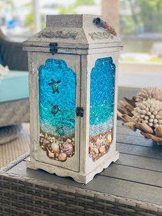 a decorative lantern sitting on top of a wooden table