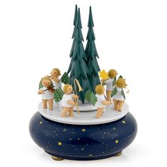 a group of figurines that are on top of a blue pot with trees