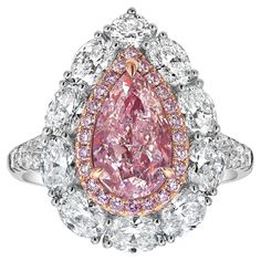 This exquisite piece features a 2.01 carat GIA-certified Very Light Pink diamond at its center, with I1 clarity. Surrounded by 1.70 carats of sparkling diamonds, the design showcases a delicate yet luxurious look. Handcrafted in 18k white gold, this ring exudes elegance with a contemporary twist. One of its standout features is the detachable head, allowing it to be worn as a pendant for added versatility. Whether worn as a ring or a pendant, this piece seamlessly adapts to your style, making it Gia Certified Luxury Pear-shaped Jewelry, Luxury Gia Certified Pear-shaped Rings, Luxury Pear-shaped Gia Certified Rings, Luxury Pear-shaped Diamond Ring With Halo Setting, Gia Certified Moissanite Diamond Ring, Pear-shaped, Gia Certified Moissanite Pear-shaped Diamond Ring, Elegant Gia Certified Pear-shaped Diamond Ring, Dazzling Pear-shaped Gia Certified Rings, Gia Certified Teardrop Diamond Ring In Fine Jewelry Style