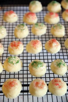 there are many small cookies on the cooling rack