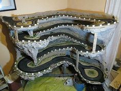 a model train set is shown in the process of being built by someone's hands