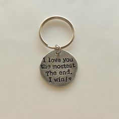 a metal keychain with a quote on it that says i love you the most