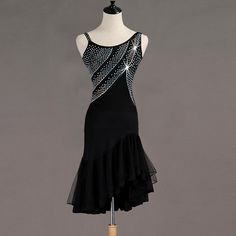 a mannequin wearing a black dress with silver sequins on the back