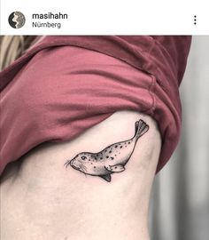 a fish tattoo on the side of a woman's stomach